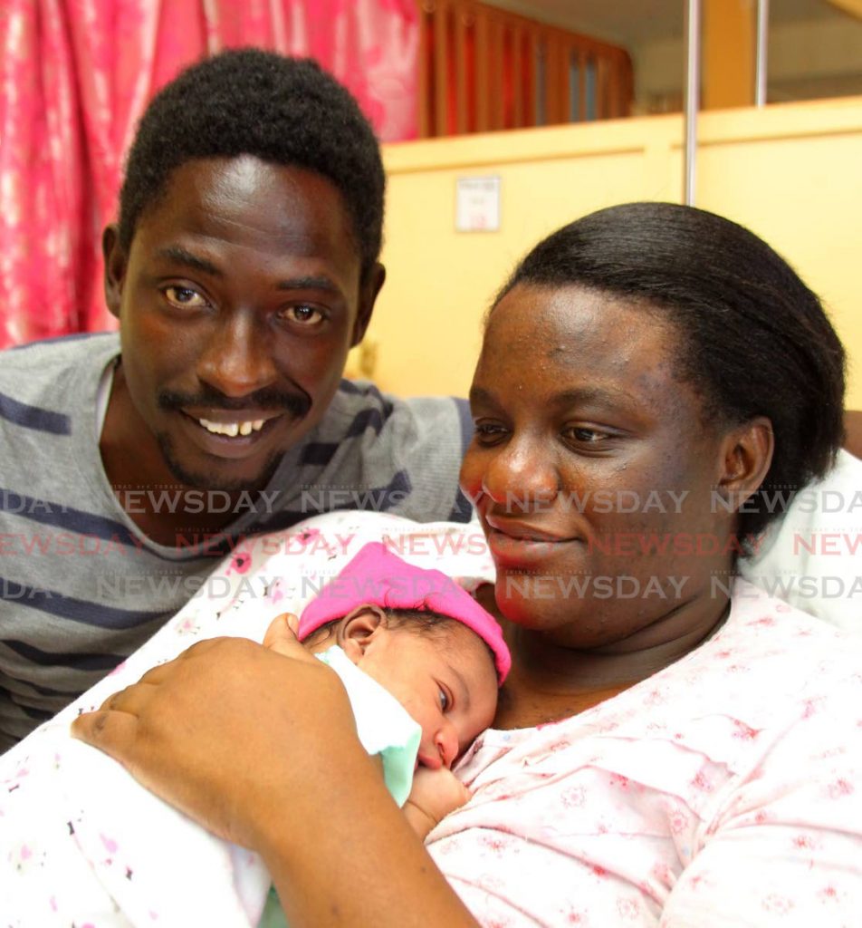 Lerawle Waldron takes a photo with his wife, Marissa Carter, and their baby daughter, Kaelen. She was born at 12. 16am on Saturday at the Port of Spain General. - ROGER JACOB