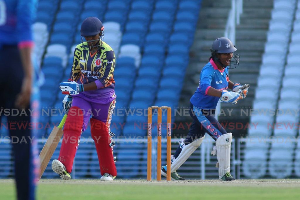 South Zone wicketkeeper Kavita Deodath (R) celebrates the dismissal of South East's Arion Neaves (L), during the final of the Girls SSCL Inter-zone Twenty20 tournament, at the Brian Lara Cricket Academy, Tarouba, on Saturday. - Marvin Hamilton