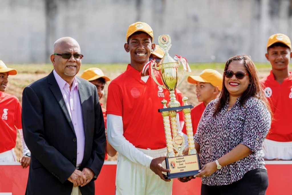 Central Zone captain Luke Ali receives the 2020 Scotiabank NextGen Under-15 Inter Zone Trophy from Scotiabank’s Cindy Mohammed, last month. At left is TT Cricket Board president Azim Bassarath
 - COURTESY TT CRICKET BOARD