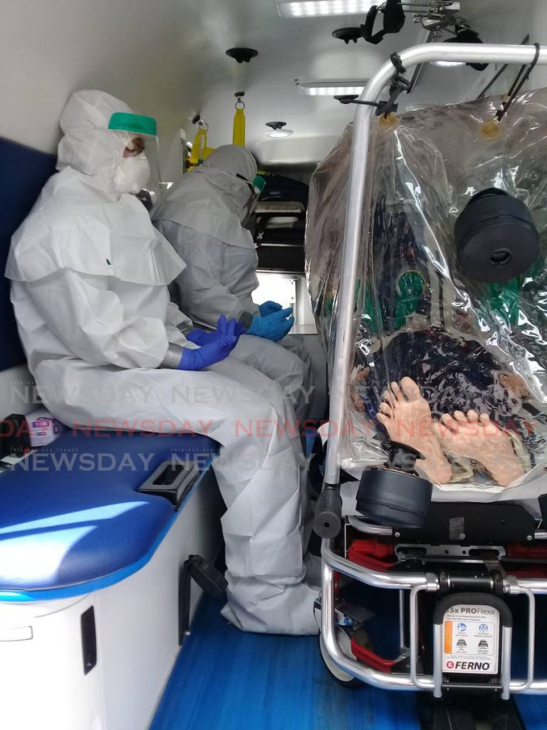 DEMONSTRATION: Medical staff demonstrate how they would transport and treat people suspected of havng the covid19 virus, during a presentation in March at the Ministry of Health in Port of Spain. PHOTO BY CAROL MATROO  - 