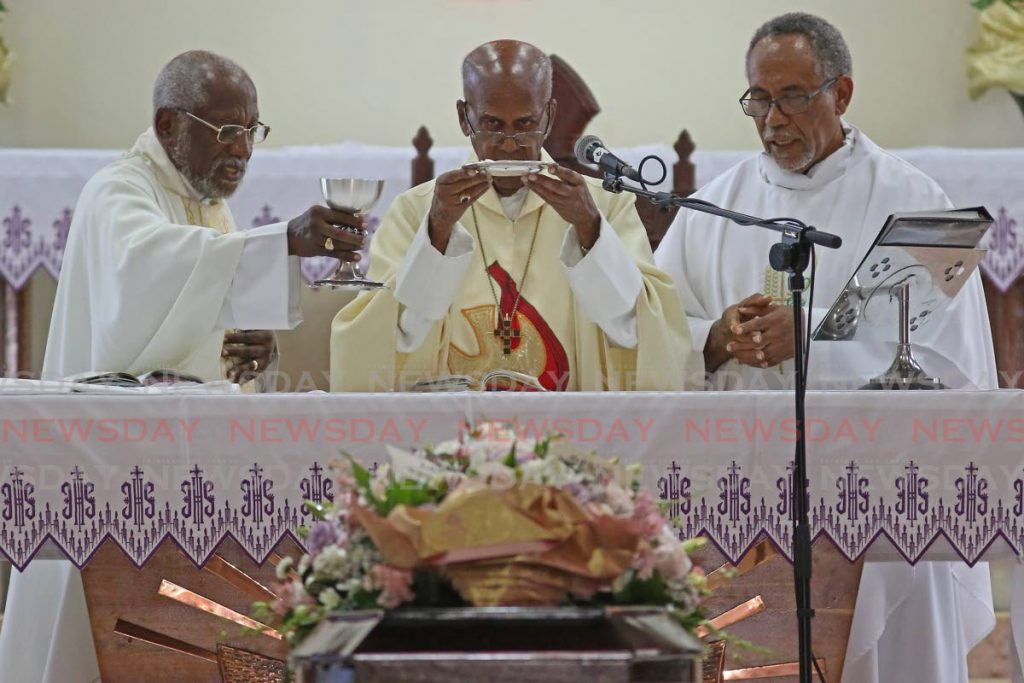 From Left: Archdeacon Emeritus Dr Steve A West, Bishop Rawle Douglin and Rev  Wayne Maughan bless the sacraments during the funeral of Joyce Cynthia Kirton, founder of Les Enfants Dance Co, at St Paul's Anglican Church, Harris Promenade, San Fernando on Wednesday. - Marvin Hamilton