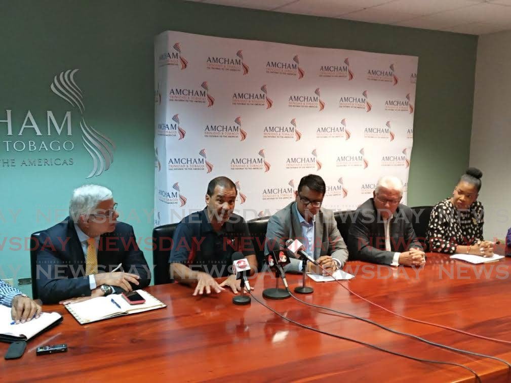 Paul Pantin, 2nd from left, the CEO of E-Zone, makes a point during a media conference on Thursday at AmCham offices on Maraval Road. PHOTO BY ANDREW GIOANNETTI - Andrew Gioannetti