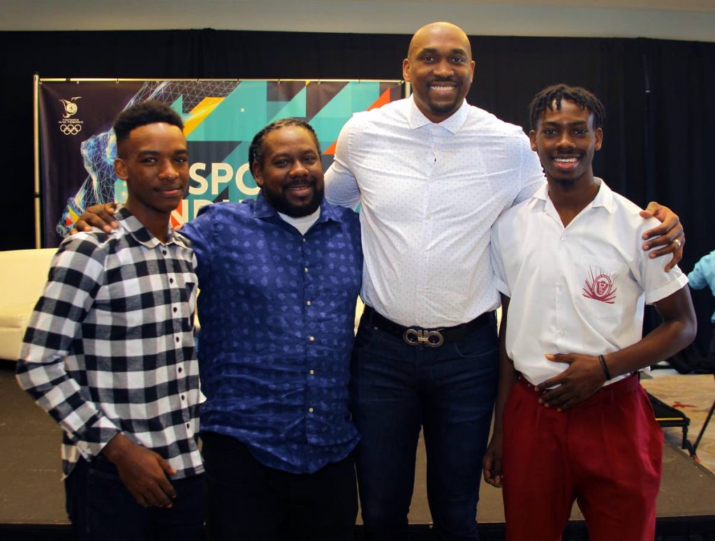Kibwe Trim (second from right), former professional basketballer and founder of DreamChaser International Foundation interacts with brothers Zion Nicholas, left, and Israel Nicholas, right, recipients of the Scholar Athlete of the Year Award 2020 from the DreamChaser International Foundation, alongside their father Kieno Nicholas at the annual TT Olympic Committee Sport Industry Conference 2020, held at the Hyatt Regency, Port of Spain, last Thursday. - ROGER JACOB
