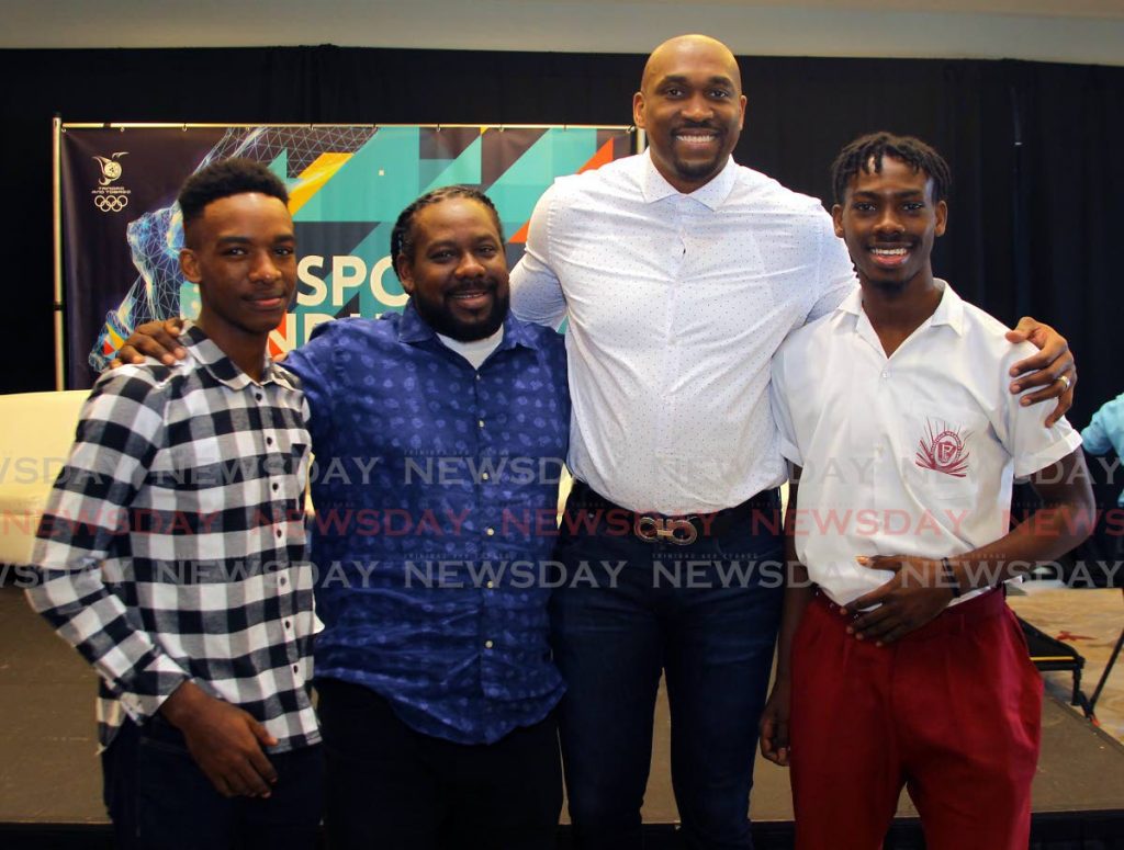 Kibwe Trim, former professional basketballer and founder of DreamChaser International Foundation, second from right, with brothers Zion Nicholas, left, and Israel Nicholas, right, recipients of the Scholar Athlete of the Year Award 2020 from the DreamChaser International Foundation, alongside their father Kieno Nicholas at the annual TT Olympic Committee Sport Industry Conference 2020, held at the Hyatt Regency, Port of Spain, on Thursday.  - ROGER JACOB