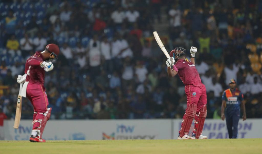 West Indies' batsman Andre Russell (right), celebrates scoring the winning run to defeat Sri Lanka by seven wickets as Shimron Hetmyer punches in the air in their second Twenty20 cricket match in Pallekele, Sri Lanka, on Friday. (AP PHOTO) - 