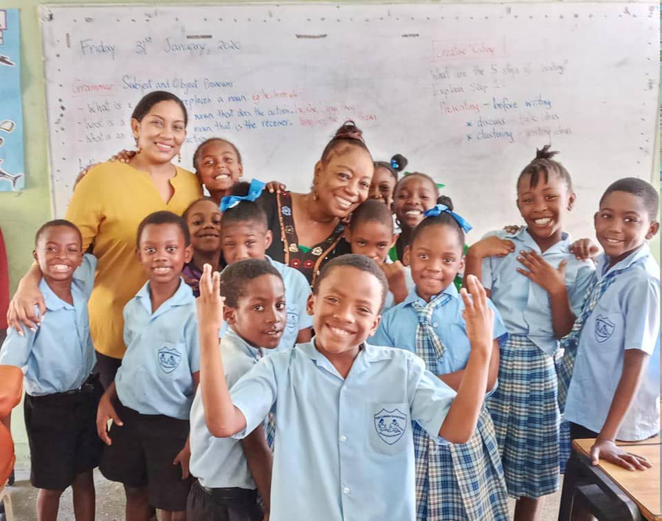 Penelope Spencer with a teacher and students of Pt Cumana RC School.  - 