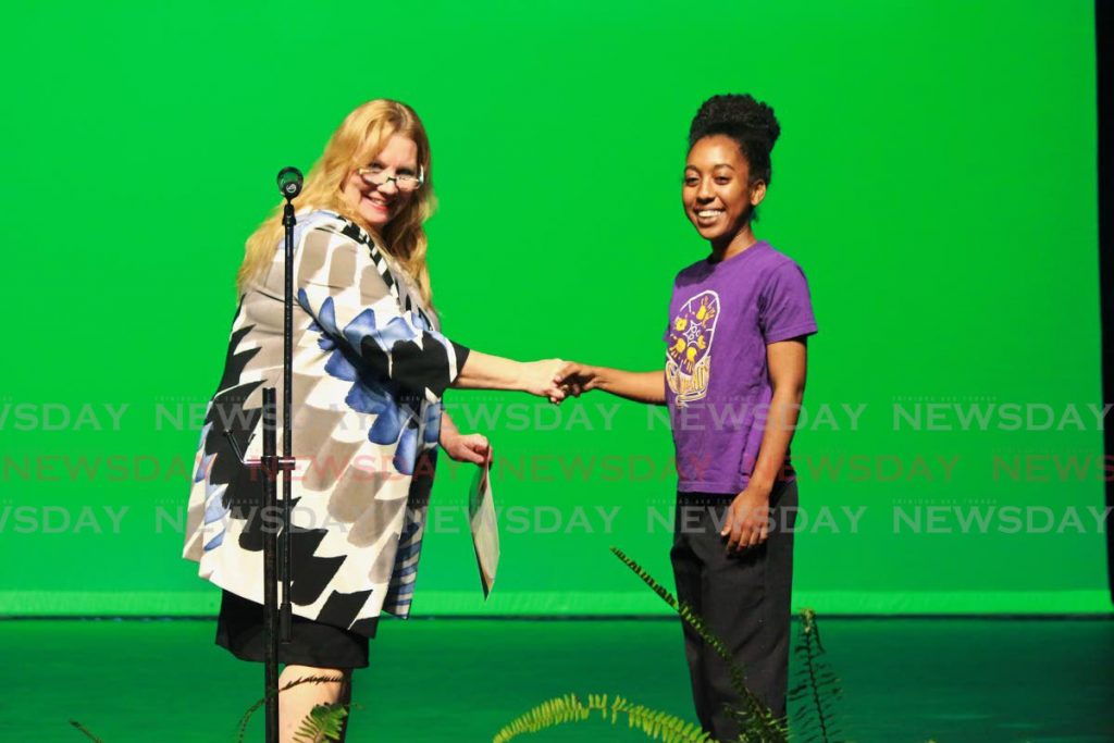 Dr Jeannine Remy congratulates Jesse Jagnarine for placing first in the Steelpan Solo 21 Years and Under at the Music Festival at the Naparima Bowl in San Fernando.   - CHEQUANA WHEELER