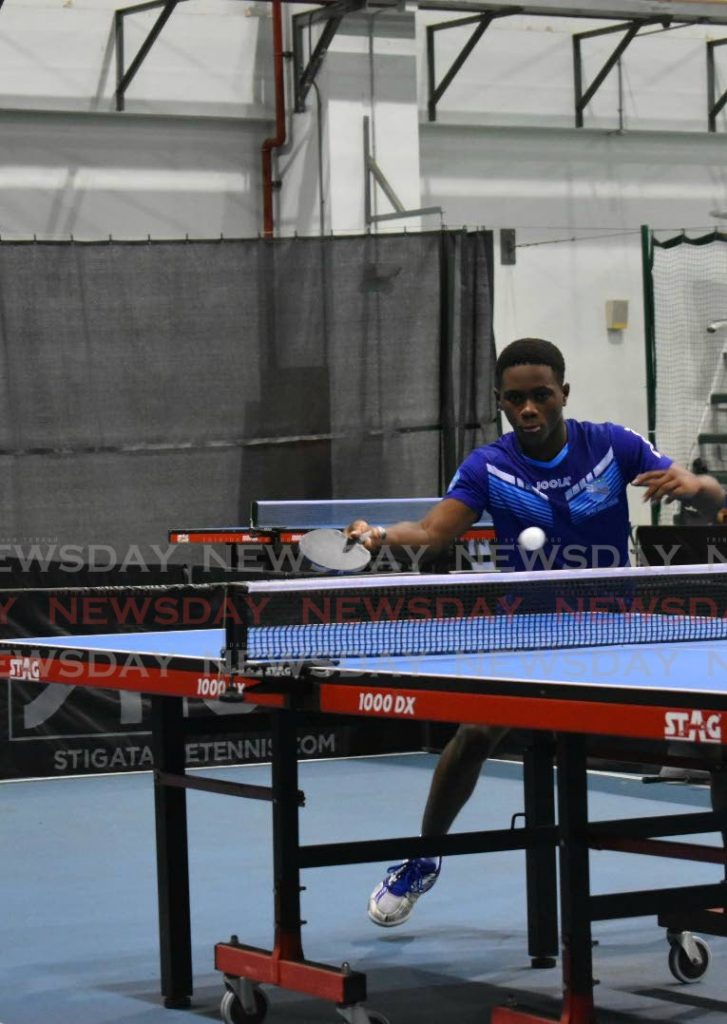 Derron Douglas returns a serve during the ICWI Junior Super Singles tournament. - Sherdon Pierre