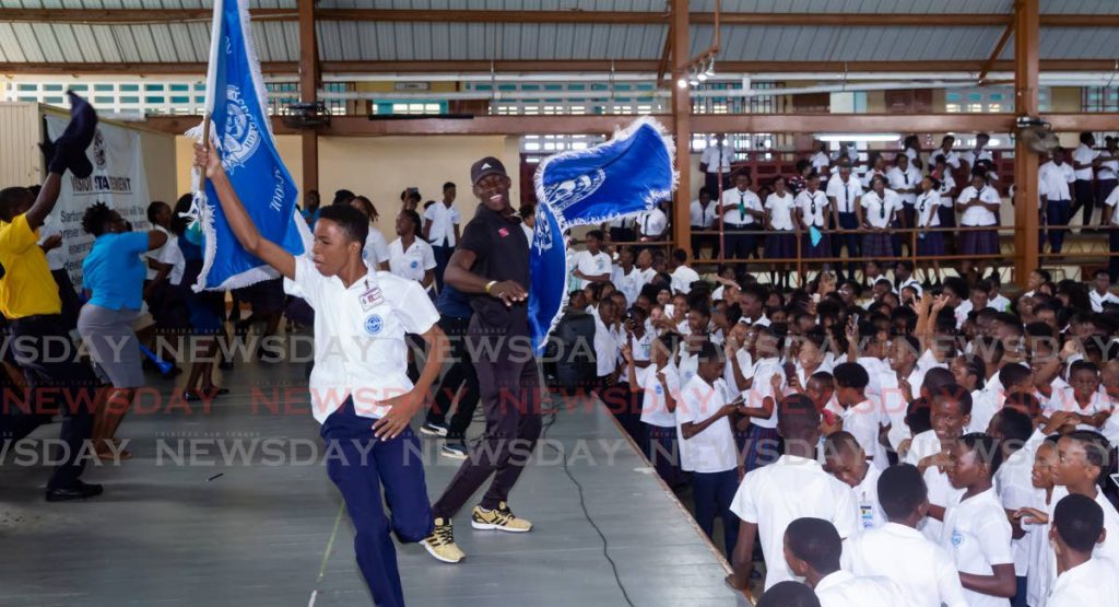 Students and teachers of Scarborough Secondary School celebrate during a pep rally on the eve of the National Secondary Schools Track and Field Championships before the school’s athletes compete, at Dwight Yorke Stadium between Wednesday and Thursday. - David Reid