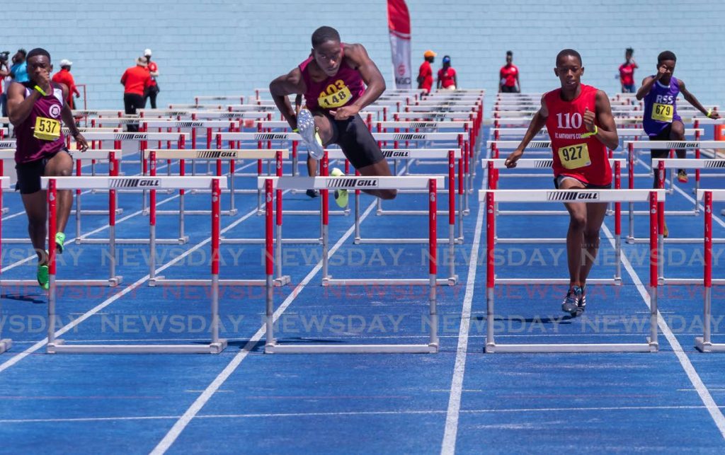 Che Saunders (C), of Bishops High School, wins his race in the Over 17 at Dwight Yorke Stadium, on Wednesday. - David Reid
