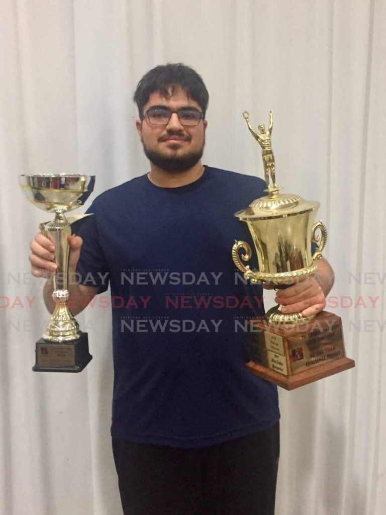 International Master Alan-Safar Ramoutar displays  his awards for National Junior Absolute title and Senior Player of the Year Award, at the TT Chess Associations awards ceremony, at Presentation College Chaguanas, on Saturday. - Yannick Quintal