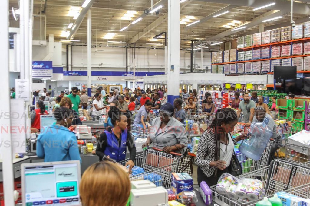 FLASHBACK: Pricesmart Members flood stores nationwide, as households attempt to acquire cleaning and sanitory products from the shelves,
Pricesmart Movietowne, Invaders Bay, Port of Spain, March 12. - ROGER JACOB