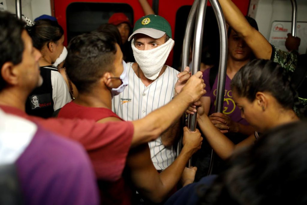 A man wears a hand towel as a makeshift protective mask, while riding on the subway in Caracas, Venezuela, Friday. AP PHOTO - 