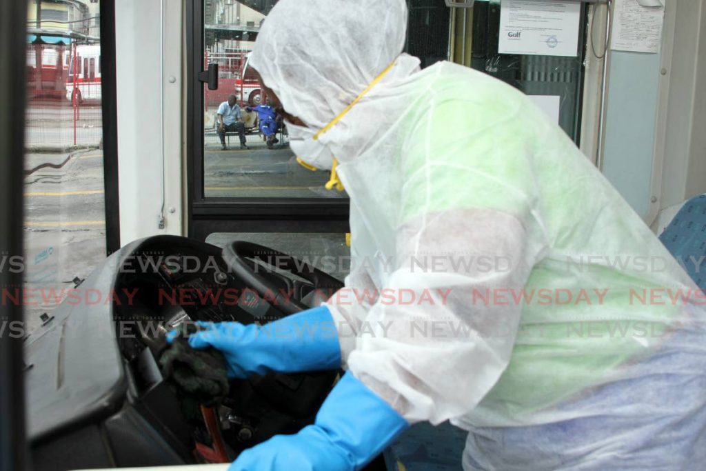 After every trip Paula Andrews of the engeneering department at the Public Transport Service Corporation (PTSC) sanitises the driver's pit in addition to the passenger seating areas in an effort to prevent the spread of the coronavirus.  - Ayanna Kinsale