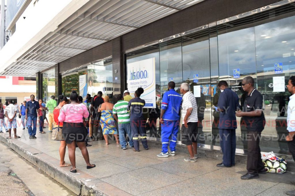 People line up outside the Independence Square branch of RBC as precautionary measures have been put in place to prevent the spread of covid19.   - Vidya Thurab