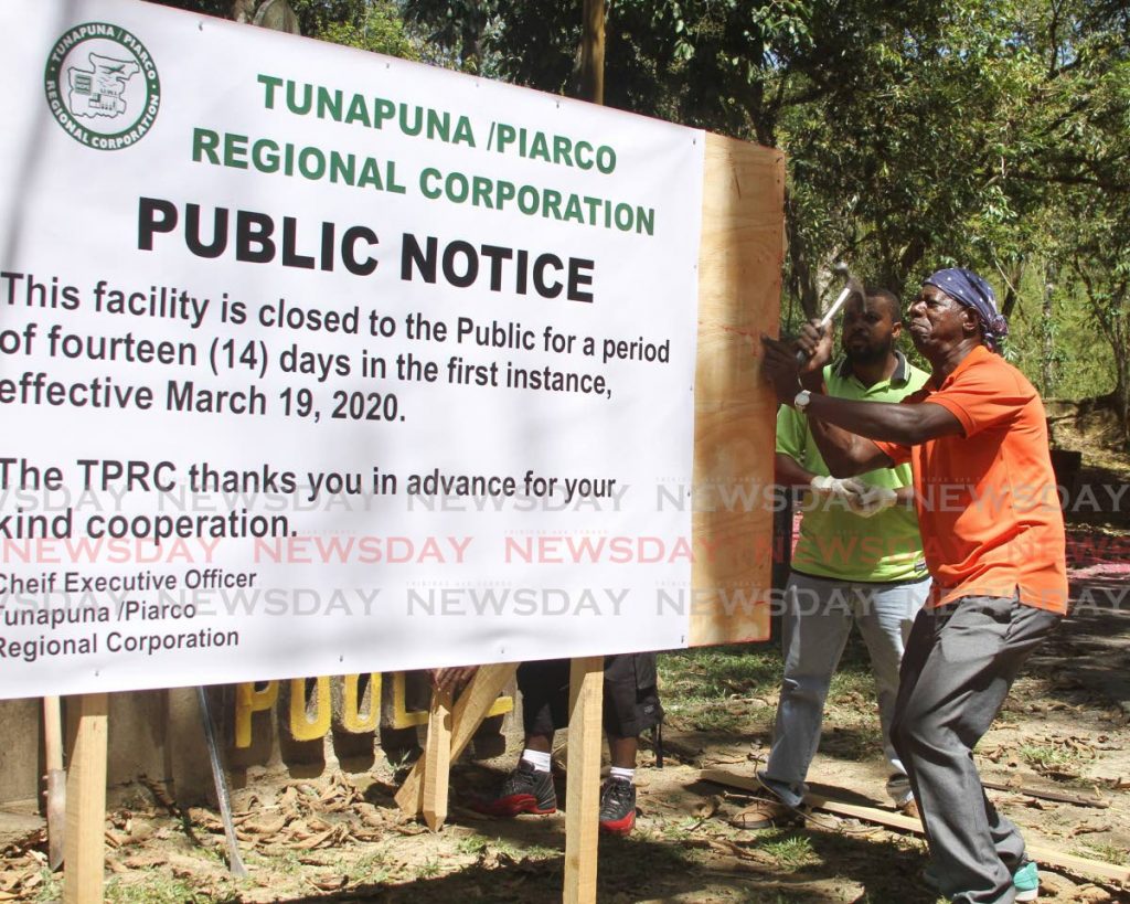 Tunapuna / Piarco Regional Corporation workers put up a sign on Thursday notifying members of the public about the closure of Pool 2 at Caura. 
PHOTO BY 
AYANNA KINSALE - Ayanna Kinsale