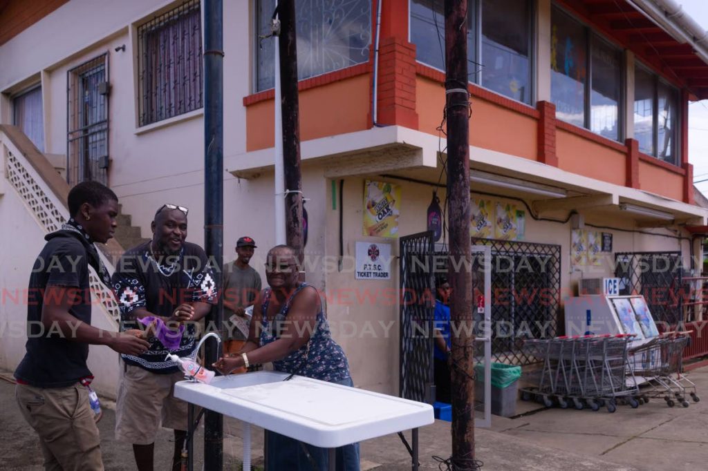 Shoppers wash their hands before entering Viewport Supermarket in Canaan on Friday. The supermarket closed its doors on Thursday amid the covid19 pandemic but reopened a day later. PHOTO BY DAVID REID - 