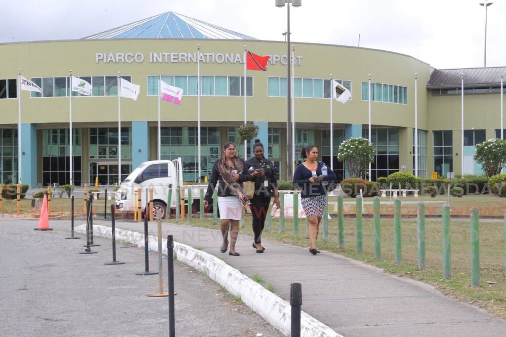 Airport staff exit the Piarco International Airport on Saturday hours after the government announced the closure of international borders by midnight on Sunday. - ROGER JACOB