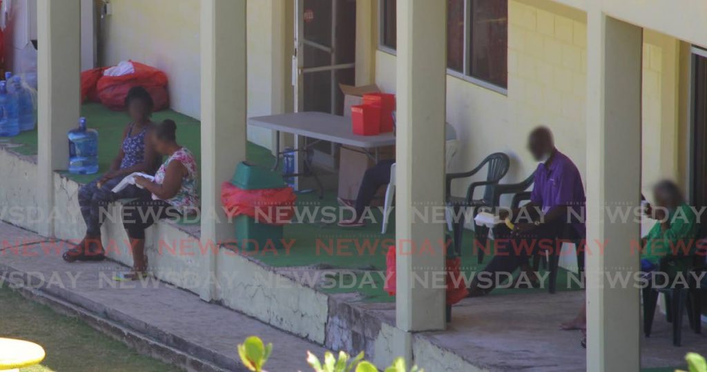 Some of the 68 people in quarantine at the Seventh-Day Adventist Church camp in Balandra relax with each other on Thursday. Forty of them have since tested positive for covid19.  - 