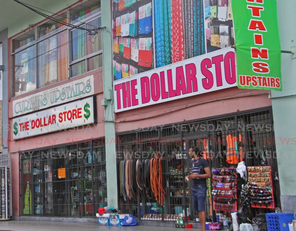 A vendor sells near several stores on Lower High Street, San Fernando.  PHOTO BY VASHTI SINGH - Vashti Singh