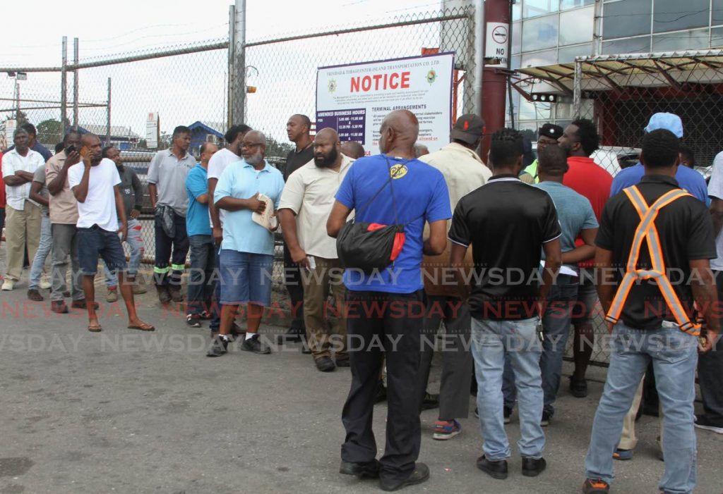 Passengers wait to be scanned before entry to the Port of Spain Ferry Terminal on Friday. - Ayanna Kinsale