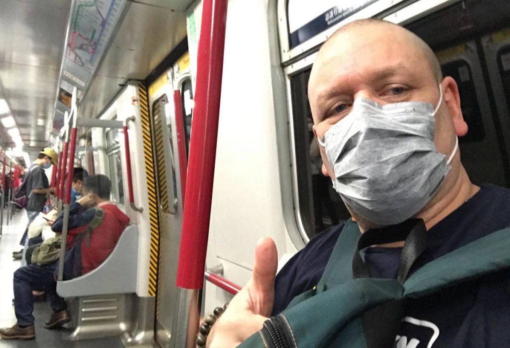 A train commuter wears a mask to protect himself from covid19 in Hong Kong. - 