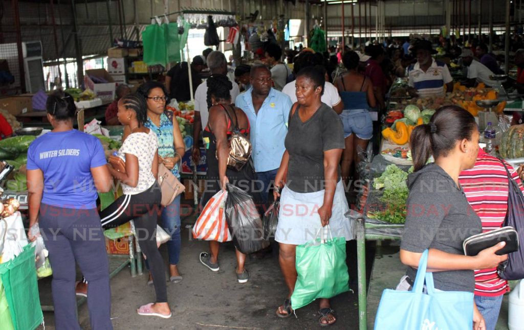Shoppers fail to keep their distance from each other as they crowd the Tunanpuna market on Saturday. PHOTO BY ANGELO MARCELLE - 