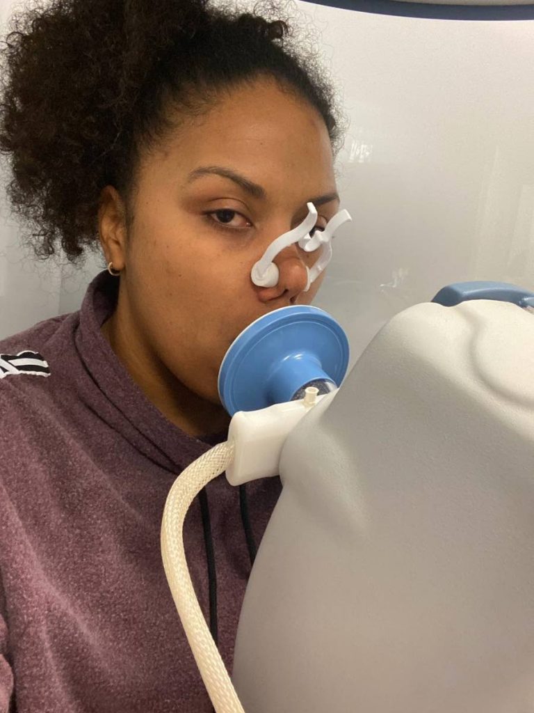 Trinidadian born Chrystal Tsoia-Sue, who lives in Atlanta, Georgia, on a spirometry machine. in an Atlanta hospital in February. - 