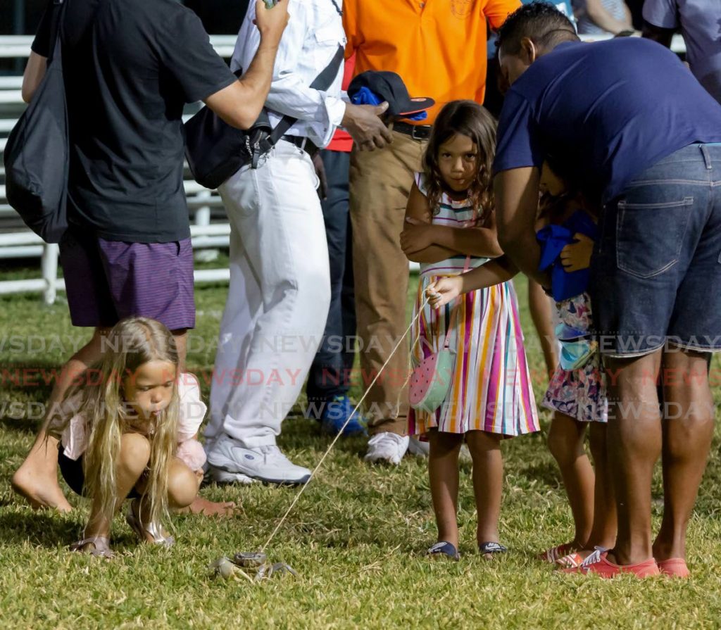 Young visitors enjoy a crab race at the Buccoo integrated facility in April last year.   - 