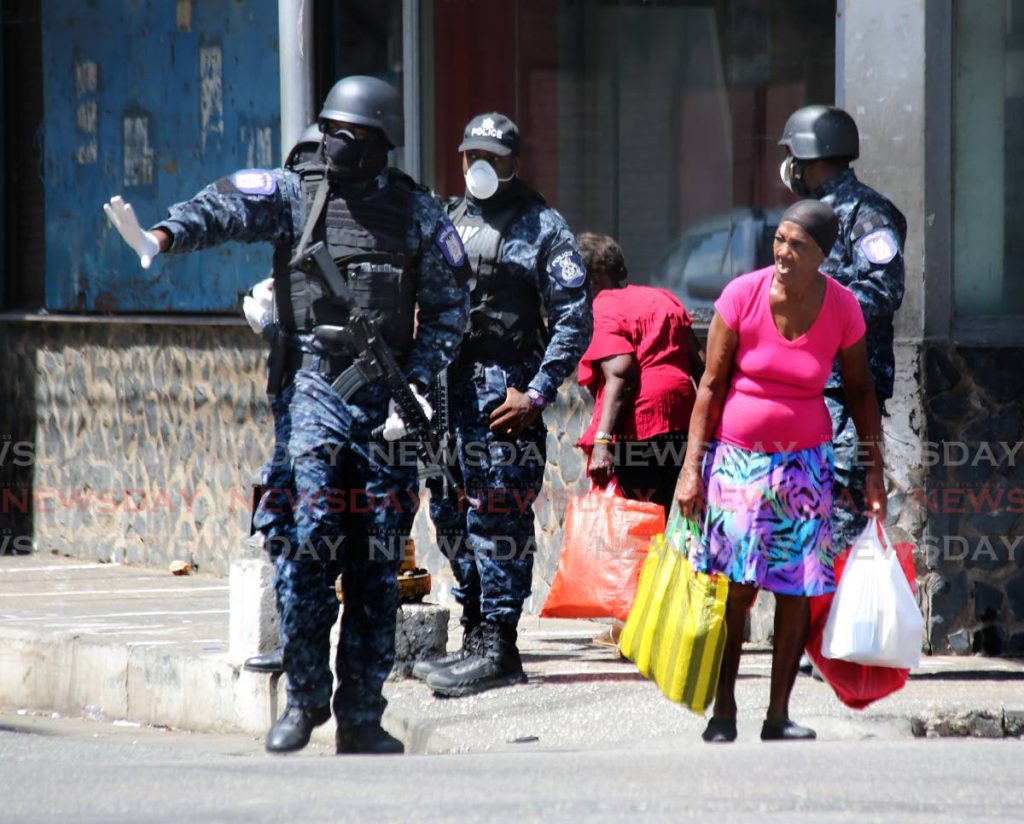 Police officers were deployed in downtown Port of Spain on Saturday and made sure people were not gathering in numbers larger than five. - SUREASH CHOLAI