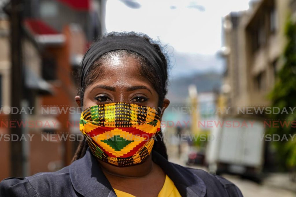 Cherisse Pierre was captured wearing a stylish mask she made herself as she crossed the street in Port of Spain. - JEFF K MAYERS