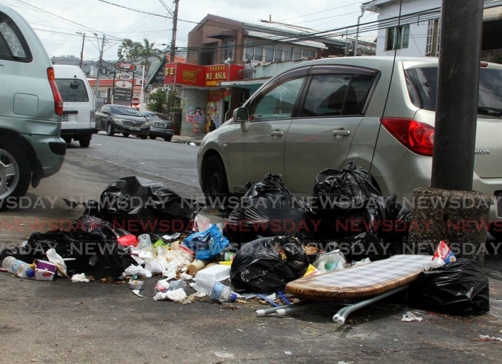 Uncollected garbage lies scattered on Tragarete Road, Woodbrook on Tuesday. - Ayanna Kinsale