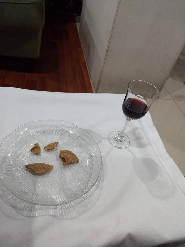 The emblems, unleavened bread and unfermented wine, ready to be passed among family members at home during a video streamed Memorial. - 