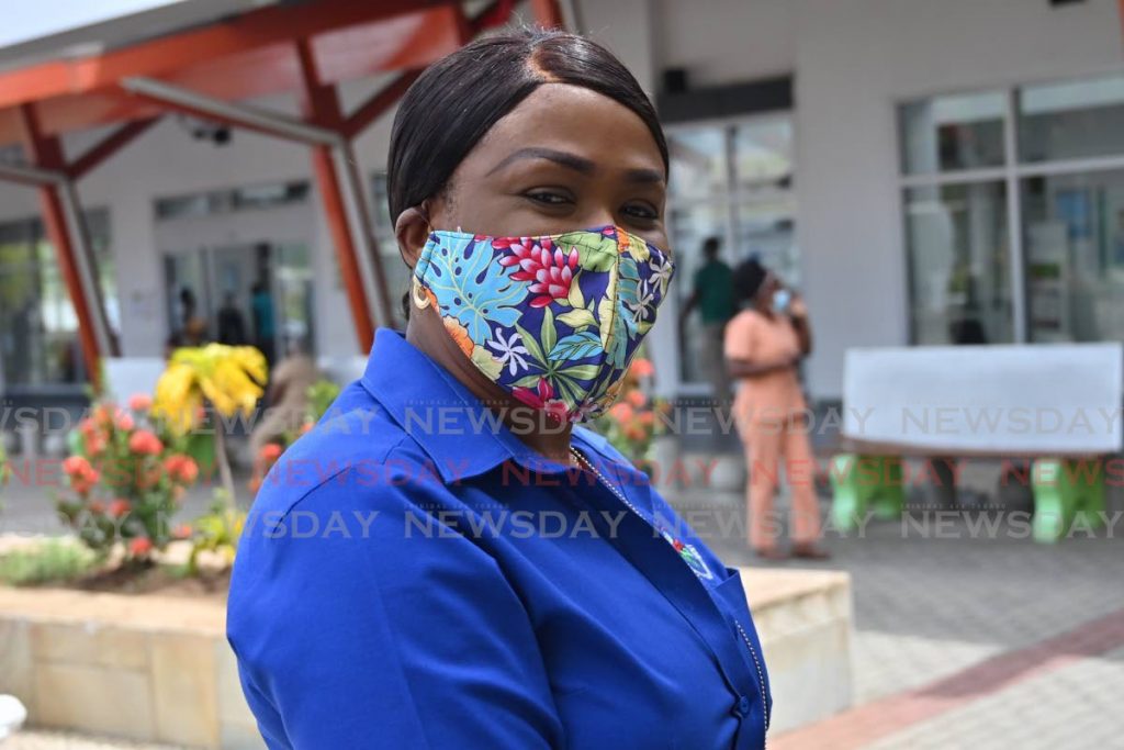 A woman wears a cloth mask while out on business in Tobago. Nipdec is inviting tenders for the manufacture of cloth masks. PHOTO BY LEANDRO NORAY - LEANDRO NORAY