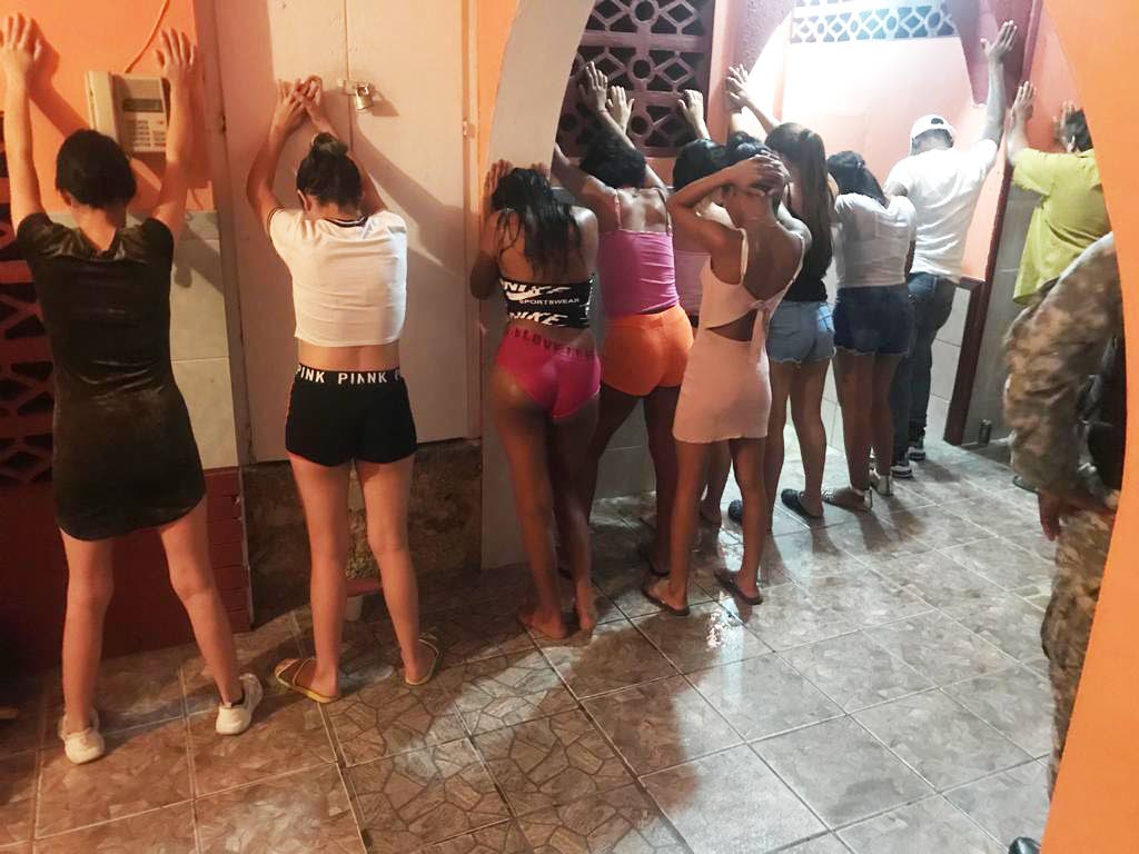 In this file photo several women, some of them scantily clad, are lined up on a wall at Alicia's Guest House after Police Commissioner Gary Griffith led a team of officers on a raid on a covid19 fete in which 16 people including Venezuelans, were arrested on Good Friday morning. PHOTO COURTESY TTPS - 