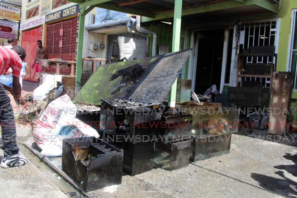 Aqauriums that once held exotic fishes stand empty and charred by a fire that destroyed Funtasticpets pet store on Guanapo Road, Arima, on Easter Monday. - SUREASH CHOLAI