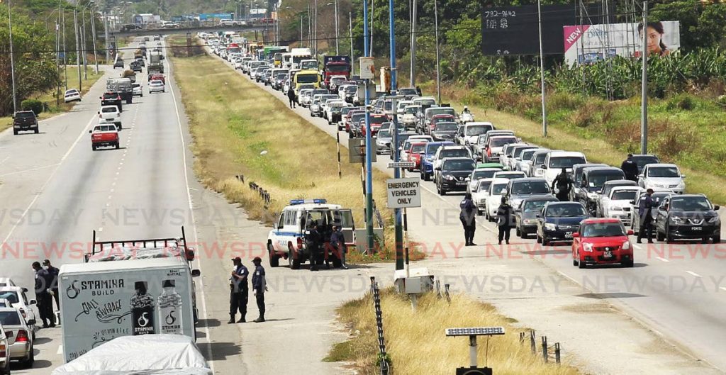 TRAFFIC WOES: Traffic for several miles along the northbound section of the Uriah Butler Highway in Chaguanas on Friday during the police’s nationwide roadblock exercise. 
PHOTO BY LINCOLN HOLDER - L Holder