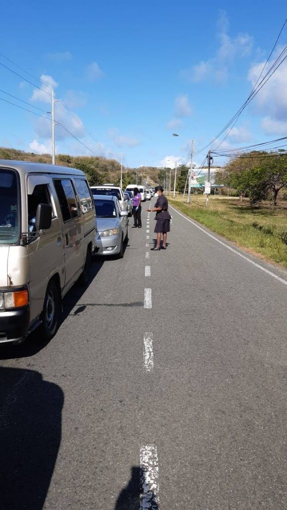 Police query drivers’ reasons for being on the road on Friday during a roadblock on the Claude Noel Highway in Bacolet. PHOTO COURTESY THE TTPS - TTPS