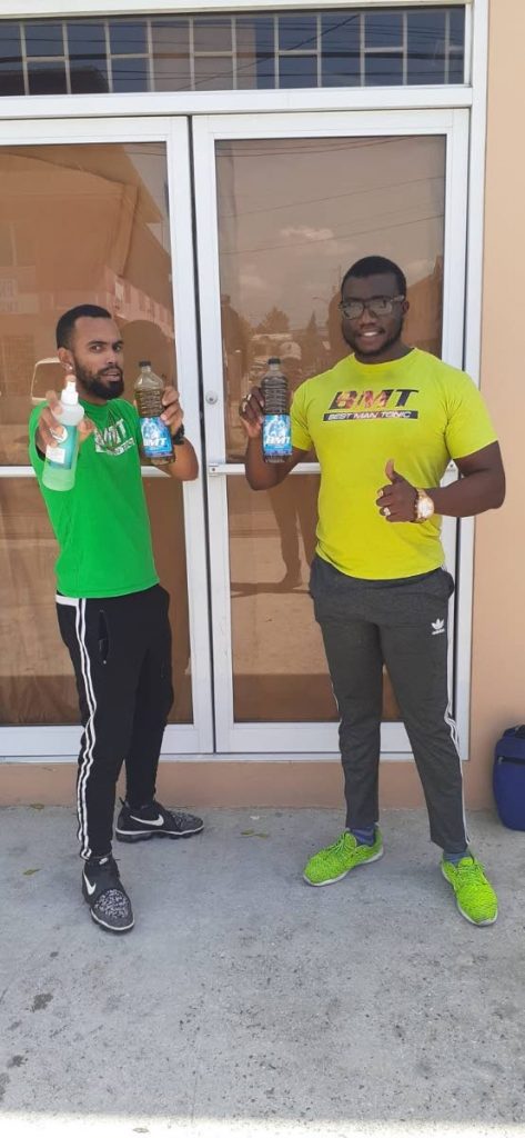 Christopher Best, right, and Roger Celestine display the Best Man Tonic. Celestine also reminds people to sanitize during the covid19 pandemic as he holds a bottle of sanitizer.  - 