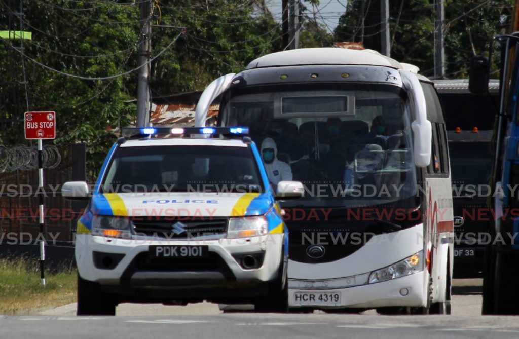 LUCKY ONES: Police escort a bus containing 16 of the 33 Trinis who returned home on Tuesday from Barbados.
 For 40 Trinis stranded 
in Suriname, 
life is getting harder 
and they now wonder 
if their govt has 
forgotten them. 
PHOTO BY
 ROGER JACOB - ROGER JACOB