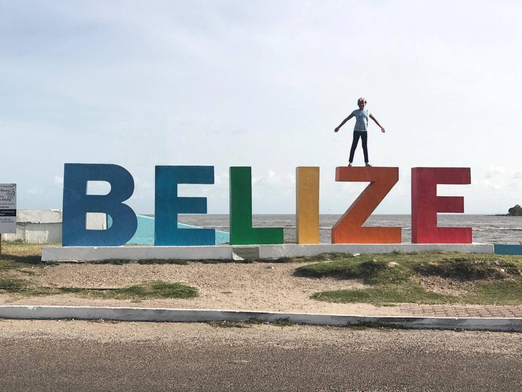 Chelsea Young loves exploring her home of country of Belize and hopes she can do soon when covid19 restrictions are lifted in the country. Here she poses atop a sign in Belize City, which was designed for tourists to take pictures.  - Photo Courtesy Nikki Augustine 