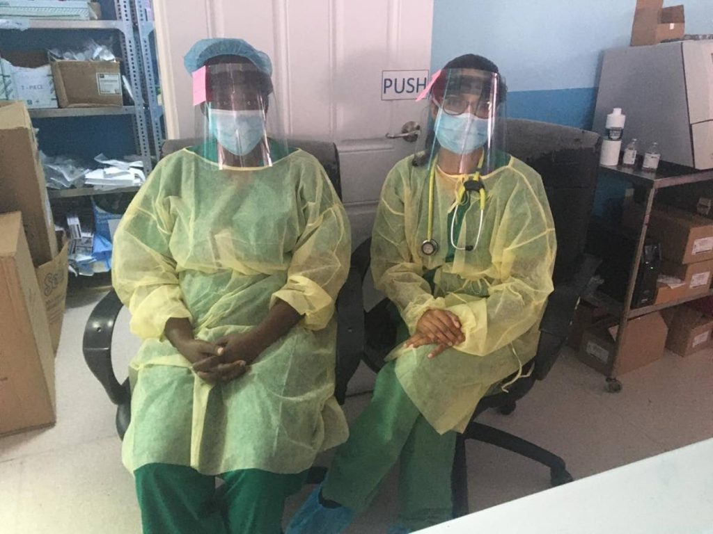 Health workers wearing locally manufactured personal protective equipment. - 