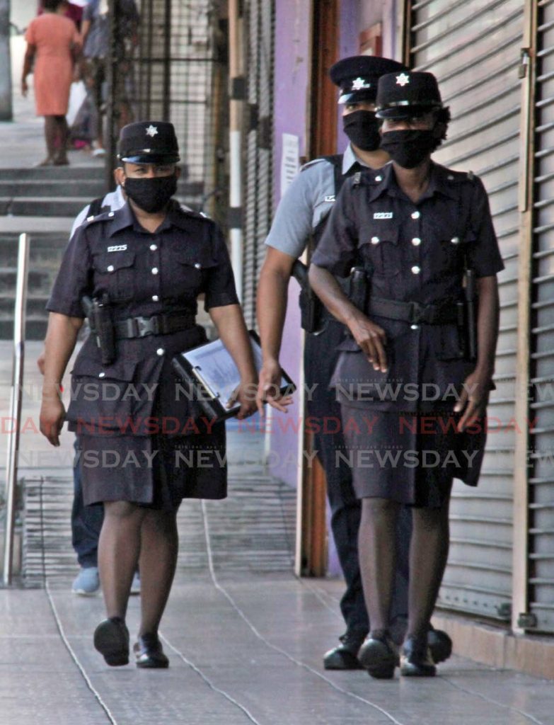 File photo: Police wear masks as they patrol High Street, San Fernando in April 2020.
