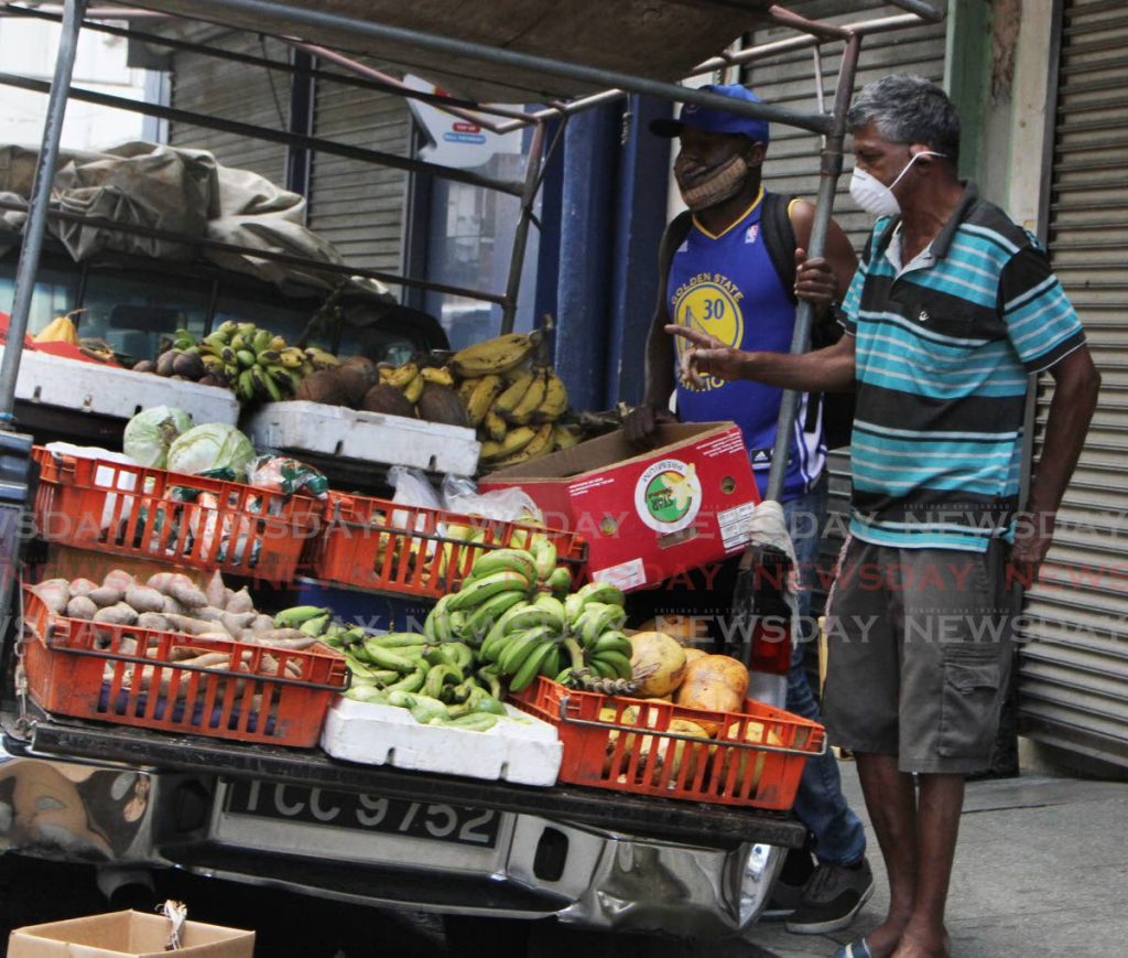 With street vending in Port of Spain now suspended by the Port of Spain City Corporation, this vendor sells his produce on Charlotte Street, Port of Spain on Sunday. The Port of Spain City Corporation stopped all street vending to help stop the spread of the covid19 virus. - ANGELO MARCELLE 