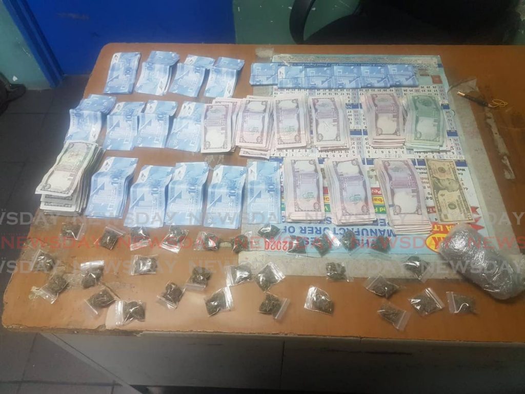 An estimated TT $28,805 and US $10 were seized together with 103 grams of marijuana at a house on Francis Street, Couva, early on Thursday.  PHOTO COURTESY TTPS - TTPS