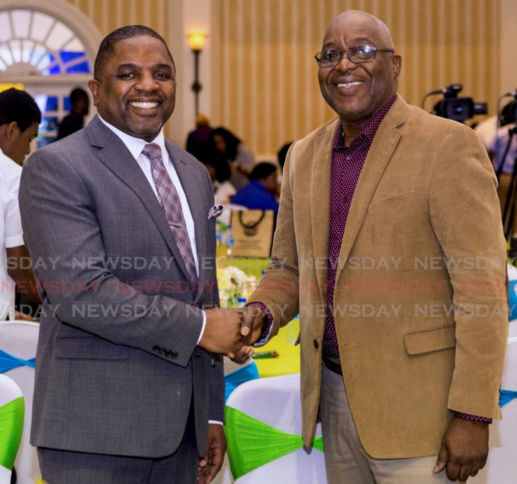 Kelvin Charles, who demitted office as chief secretary of the THA on Thursday, shakes hands with Deputy Chief Secretary Joel Jack at a function in Tobago last year.  - DAVID REID 