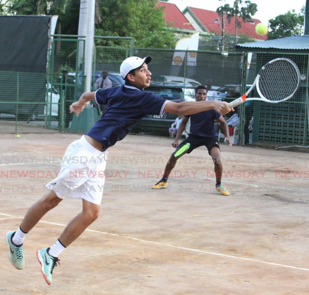 In this March 11, 2020 file photo, Nathan Valdez (left) plays a shot while his partner Jaydon Alexis watches on, during a men's doubles match against Richard Chung and Dexter Mahase, in the Shell Tranquillity Open Tennis tournament, at the Tranquillity Tennis Courts, Victoria Avenue, Port of Spain. PHOTO BY ANGELO MARCELLE - Angelo Marcelle