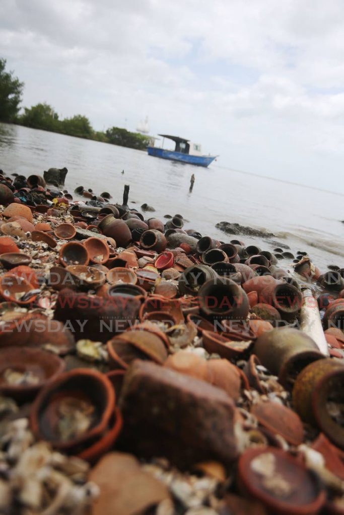 Used and discarded deyas and clay pots litter the seashore near the Sewdass Sadhu Shiva Mandir Temple in the Sea, Waterloo, on May 5. - Lincoln Holder