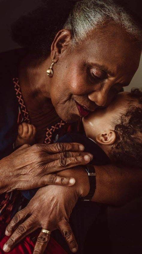 Valerie Laurent-Thomas hugs her grandchild Romeo Stephens. - 