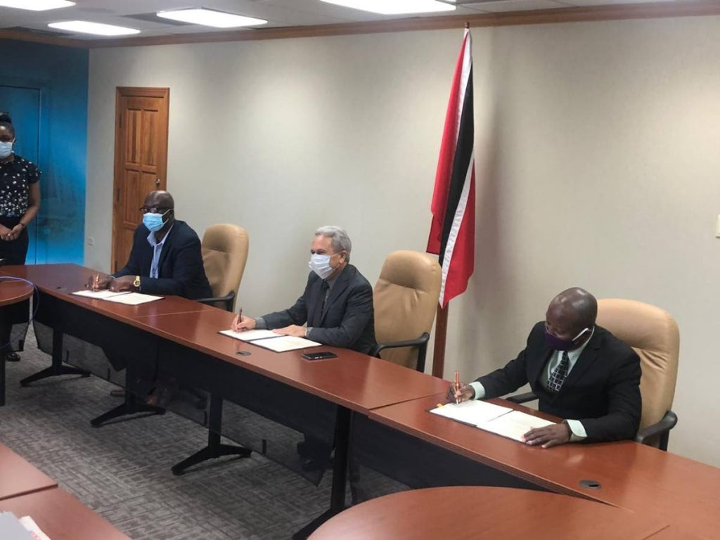 SIGNED: Finance Minister Colm Imbert, centre, president of the Cooperative Credit Union League Joseph Remy, left, and vice president of the Central Finance Facility Lyndon Byer at the signing of the loan facility agreement. PHOTO COURTESY CENTRAL FINANCE FACILITY  